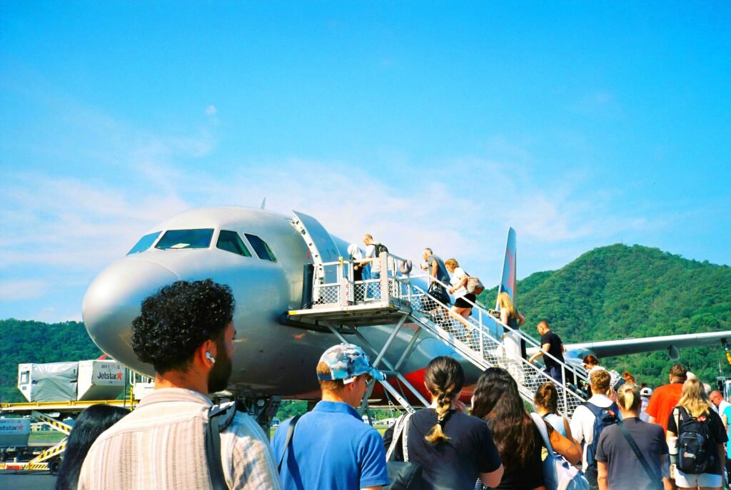 People Waiting In Line To Board Plane Showing That The Sooner You Start Is The Sooner You Finish.