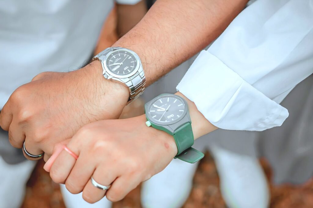 Couple Show Left Hand With Watch & Wedding Ring Showing, Symbolising Time & Love.