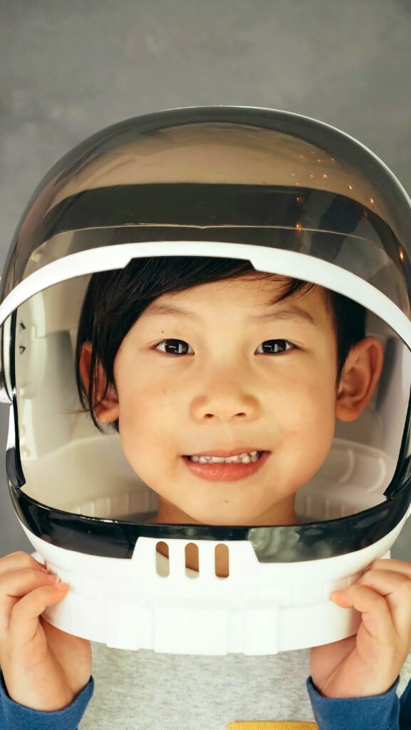 Young asian girls is dressed as an astronaut signifying that shooting for the moon is her thing.
